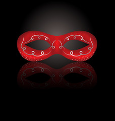 Theater red mask with reflection on black background