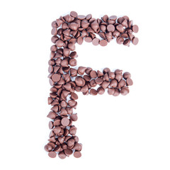 Alphabet from chocolate chips on white background