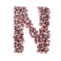 Alphabet from chocolate chips on white background