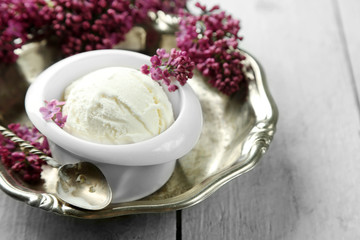 Beautiful composition with tasty ice cream and lilac flowers