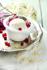Beautiful composition with tasty ice cream and lilac flowers