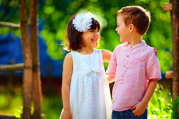 cute laughing children having fun outdoors, summertime