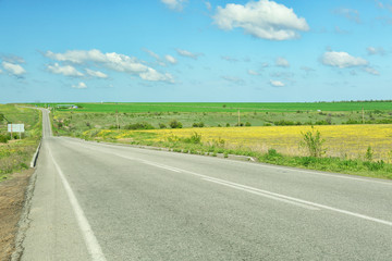 Fototapeta na wymiar Country road over blue sky background