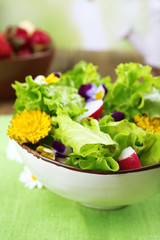 Light organic salad with flowers, close up