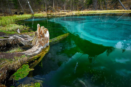 Geyser lake with clear cyan water in Altai mountains
