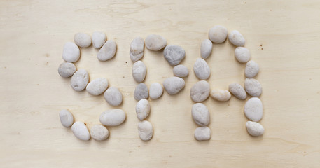 Spa stone text on wood background