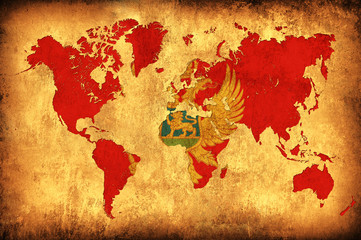 The flag of Montenegro in the outline of the world map