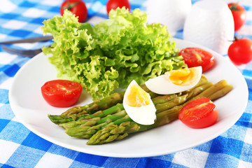 Plate of dietary salad with boiled asparagus and egg, closeup