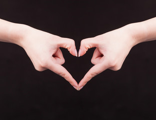 Woman hand making sign Heart