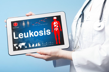 Girl holding Tablet with the diagnosis Leukosis on the display.