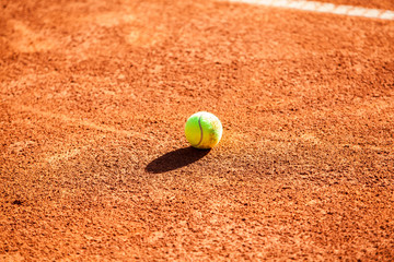 Tennis balls on the clay court.