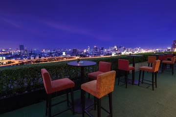 Restaurant dining table and view of business building on terrace