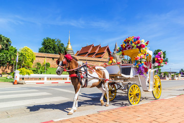 Horse carriage front of Wat Phrathat Lampang temple - obrazy, fototapety, plakaty