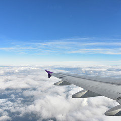 Fototapeta na wymiar See through plane window with blue sky and clouds outside