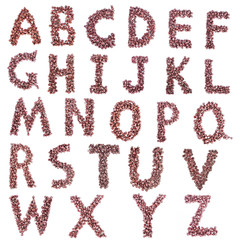 Alphabet from chocolate chips on white background