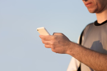 Male hands using cell phone