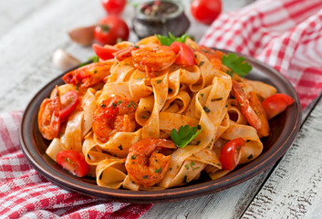 Fettuccine pasta with shrimp, tomatoes and herbs