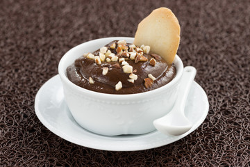 chocolate mousse with biscuits on a brown background