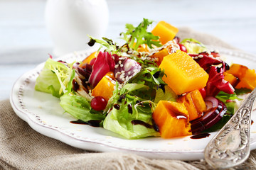 Healthy salad with baked pumpkin