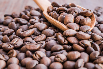Coffee beans in an old wooden scoop