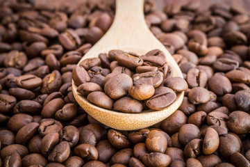 old wooden spoon with coffee beans