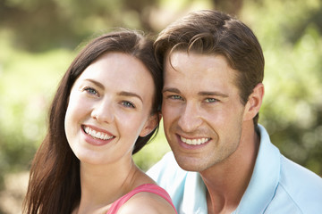 Obraz premium Portrait Of Young Couple Relaxing In Countryside