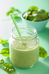 healthy green smoothie with spinach mango banana in glass jars