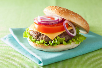 burger with beef patty cheese lettuce onion tomato