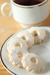 Fototapeta na wymiar Italian Canestrelli biscuits on the saucer near a cup of black tea