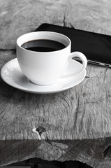 Fototapeta na wymiar coffee cup on wood monochrome