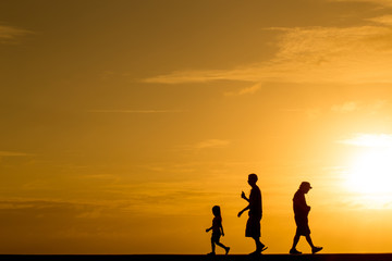 Fototapeta na wymiar Silhouette people walking at sunset