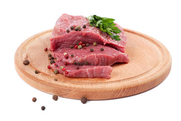 Meat on a cutting board isolated on white background.
