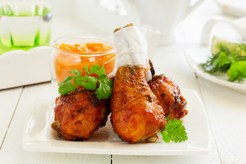 Roasted chicken legs with barbecue sauce with mango chutney.