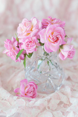 Beautiful fresh pink roses on a table .light background.