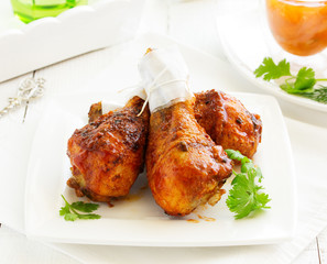 Roasted chicken legs with barbecue sauce with mango chutney.