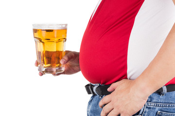 Obese man with big belly holding a glass of cold beer