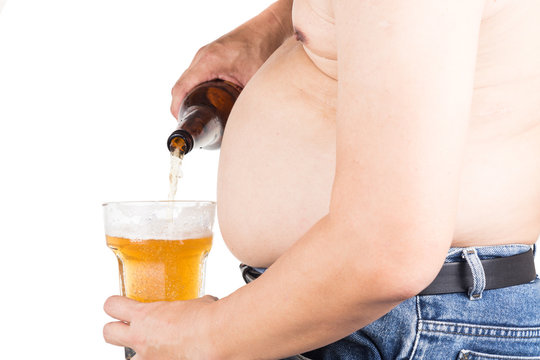 Obese man with big belly pouring a glass of refreshing beer