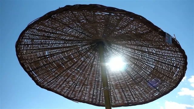Beach parasol moves in the wind