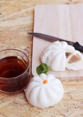 steamed pork buns, chinese dim sum and hot tea