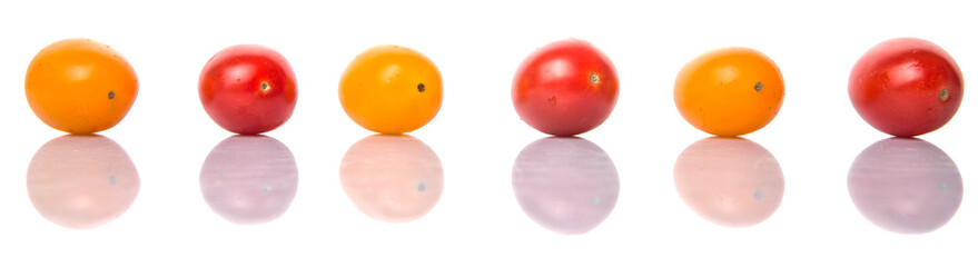 Yellow and red grape tomato over white background