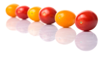 Yellow and red grape tomato over white background