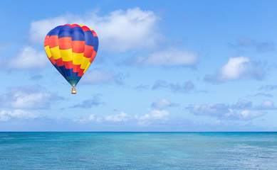Fototapeta na wymiar Colorful hot air balloon fly over the blue sea