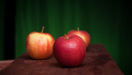 juicy apples on a wood background