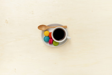 Black coffee with wooden spoon with space on wood background