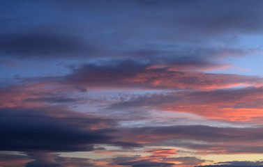 Naklejka na ściany i meble Dramatic sunset sky with orange colored clouds.