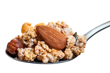 Spoon with crunchy muesli and nuts.