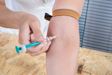 Young woman with drug addiction, pills and syringe