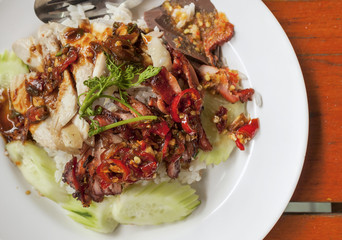 Closeup Thai style grill chicken with rice and spicy red chilli sauce