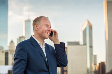 Businessman using phone outside the offices