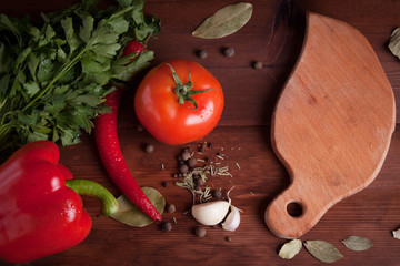 vegetables and spices on wood desk with cutting board